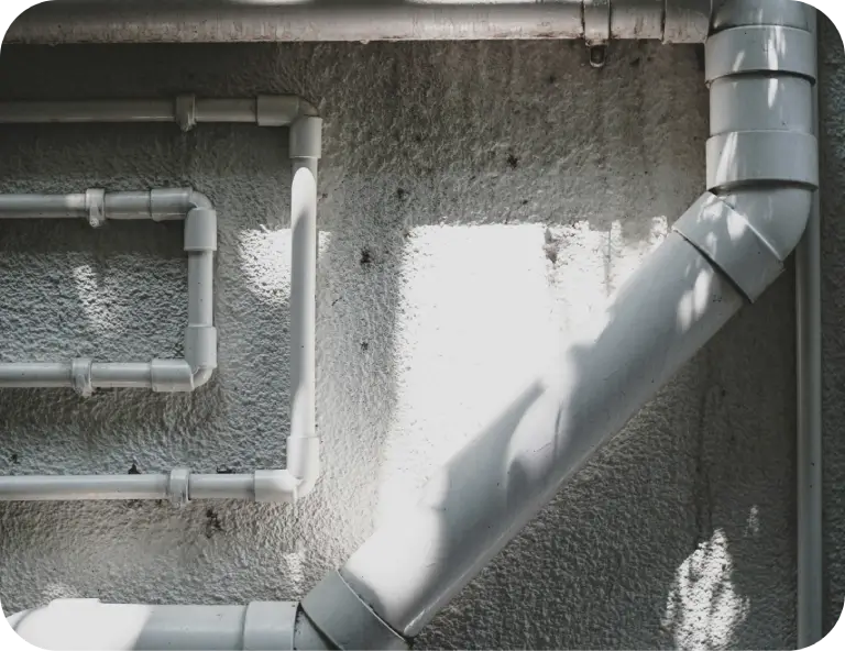 white pipes mounted on a wall